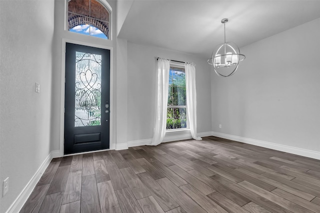 126 Capriccio Ln, Montgomery, TX 77316 - entrance foyer featuring a chandelier, dark wood-style flooring, and baseboards