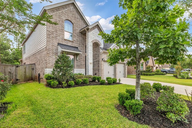 126 Capriccio Ln, Montgomery, TX 77316 - view of front of property featuring brick siding, driveway, stone siding, and an attached garage