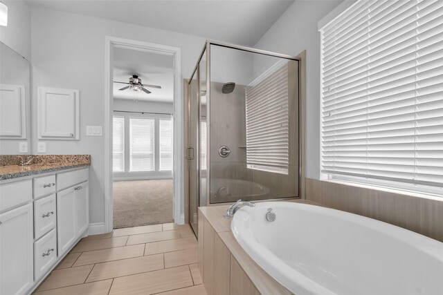 126 Capriccio Ln, Montgomery, TX 77316 - full bath featuring a garden tub, vanity, a shower stall, ceiling fan, and tile patterned floors