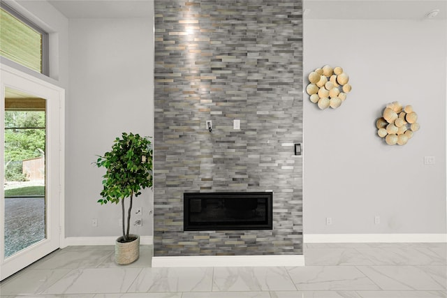 19236 Yellow Chestnut Ln, New Caney, TX 77357 - unfurnished living room with marble look tile flooring, baseboards, and a tile fireplace