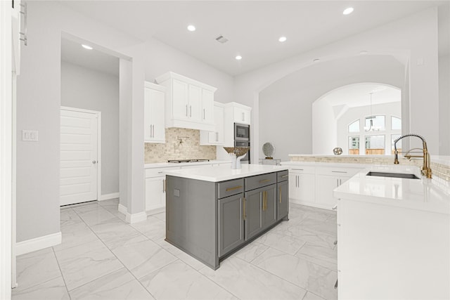 19236 Yellow Chestnut Ln, New Caney, TX 77357 - kitchen featuring light marble finish flooring, stainless steel appliances, a sink, gray cabinetry, and recessed lighting