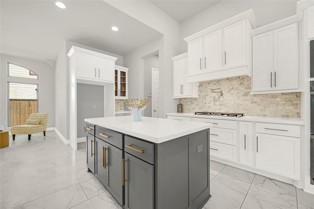 19236 Yellow Chestnut Ln, New Caney, TX 77357 - kitchen with light marble finish flooring, gray cabinetry, white cabinets, stainless steel gas cooktop, and recessed lighting