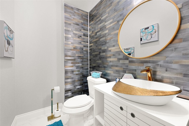 19236 Yellow Chestnut Ln, New Caney, TX 77357 - half bathroom with toilet, vanity, tile walls, decorative backsplash, and baseboards