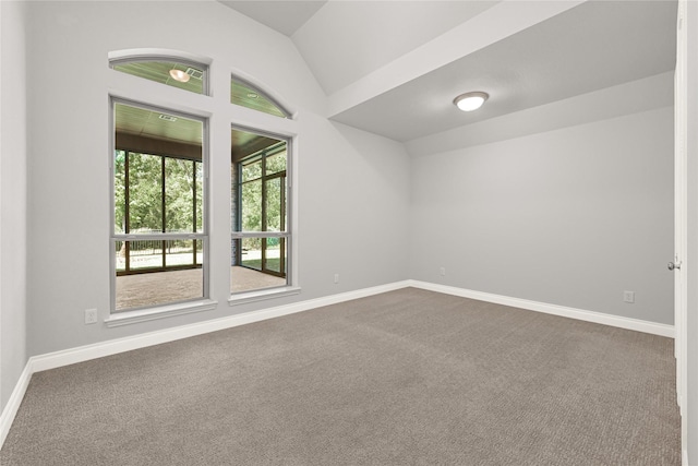 19236 Yellow Chestnut Ln, New Caney, TX 77357 - empty room featuring dark colored carpet, lofted ceiling, and baseboards