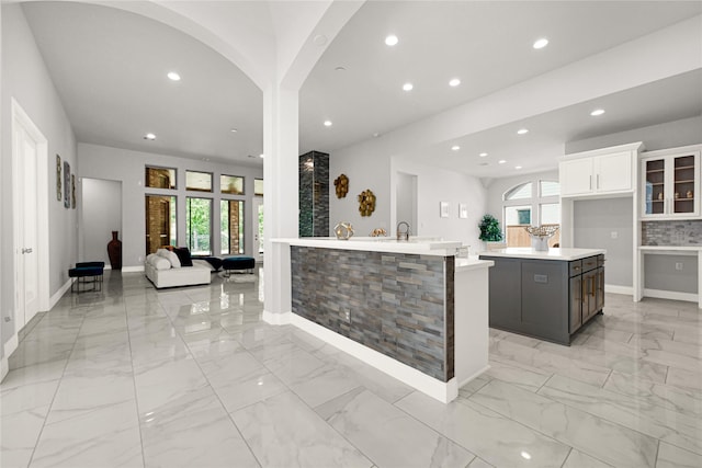 19236 Yellow Chestnut Ln, New Caney, TX 77357 - kitchen with recessed lighting, light countertops, baseboards, light marble finish floors, and a center island