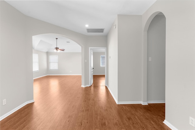 20911 Lonely Star Ln, Richmond, TX 77406 - spare room featuring wood finished floors, a ceiling fan, arched walkways, baseboards, and recessed lighting