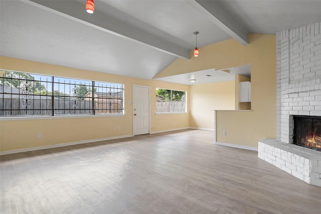 14118 Magnolia Springs Dr, Houston, TX 77066 - unfurnished living room with wood finished floors, a brick fireplace, and baseboards