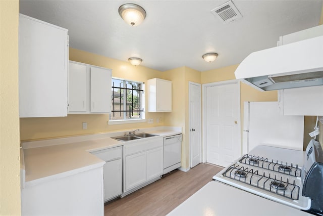 14118 Magnolia Springs Dr, Houston, TX 77066 - kitchen featuring white appliances, a sink, light wood finished floors, exhaust hood, and white cabinets