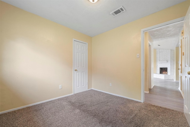 14118 Magnolia Springs Dr, Houston, TX 77066 - carpeted spare room with a fireplace and baseboards