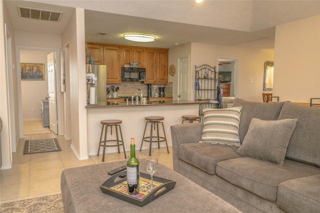 22113 Matagorda Dr, Galveston, TX 77554 - living room featuring light tile patterned floors and baseboards