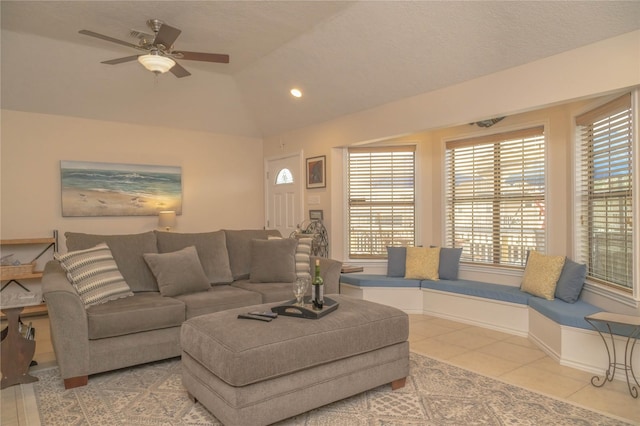 22113 Matagorda Dr, Galveston, TX 77554 - living area featuring healthy amount of natural light, light tile patterned floors, ceiling fan, and vaulted ceiling