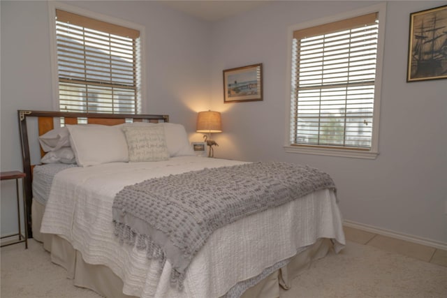 22113 Matagorda Dr, Galveston, TX 77554 - carpeted bedroom featuring multiple windows and baseboards