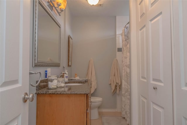 22113 Matagorda Dr, Galveston, TX 77554 - bathroom with vanity, toilet, tile patterned floors, and baseboards