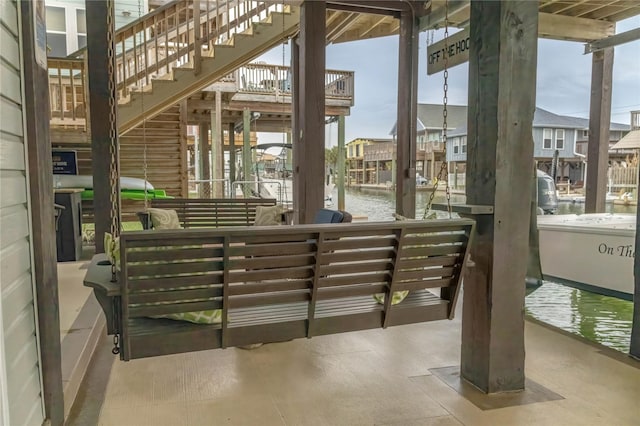 22113 Matagorda Dr, Galveston, TX 77554 - view of patio / terrace featuring a water view, stairs, boat lift, and a dock