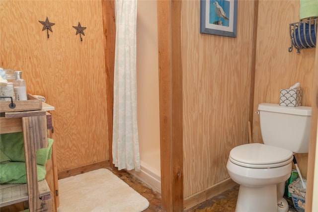 22113 Matagorda Dr, Galveston, TX 77554 - bathroom with toilet, baseboards, and a shower with shower curtain