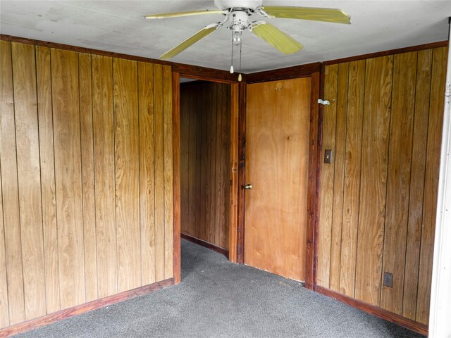 3200 Moore Ave, Bay City, TX 77414 - carpeted empty room with ceiling fan and wood walls