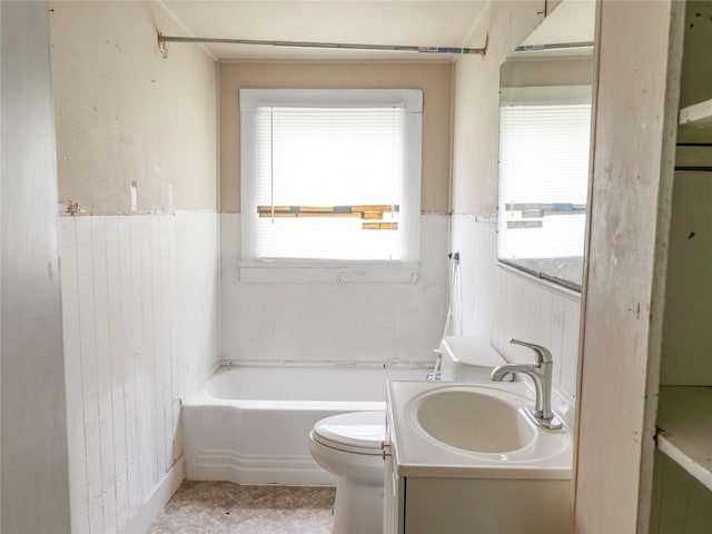 3200 Moore Ave, Bay City, TX 77414 - bathroom featuring toilet, a bathtub, tile walls, vanity, and healthy amount of natural light