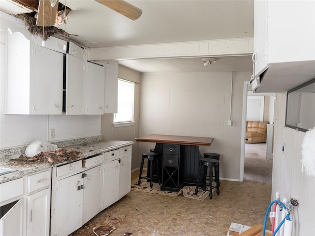 3200 Moore Ave, Bay City, TX 77414 - kitchen featuring white cabinets and backsplash