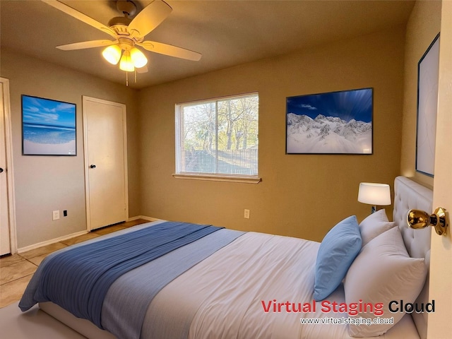 5306 Deborah Ln, Baytown, TX 77521 - bedroom featuring a ceiling fan, tile patterned floors, and baseboards