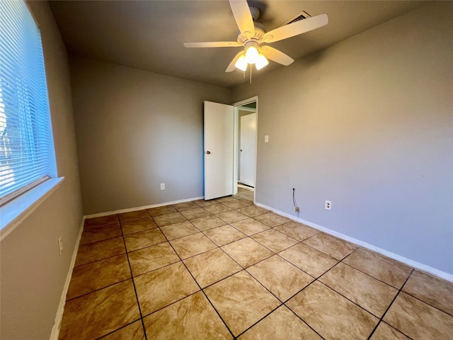 5306 Deborah Ln, Baytown, TX 77521 - unfurnished room with light tile patterned floors, ceiling fan, and baseboards