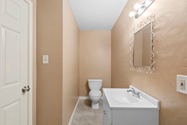 8726 Tilgham St, Houston, TX 77029 - bathroom featuring baseboards, vanity, and toilet