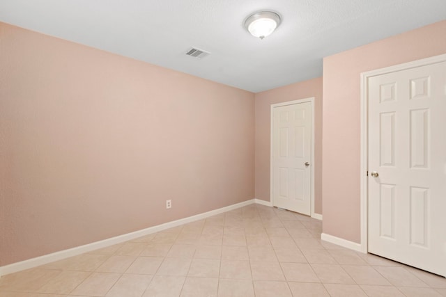 8726 Tilgham St, Houston, TX 77029 - unfurnished bedroom with baseboards and light tile patterned floors