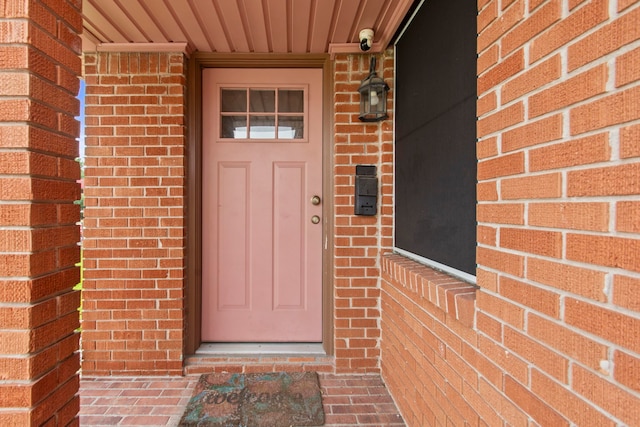 8726 Tilgham St, Houston, TX 77029 - entrance to property featuring brick siding, a surveillance system, and a porch