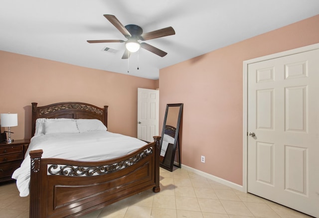 8726 Tilgham St, Houston, TX 77029 - bedroom with baseboards, light tile patterned flooring, and a ceiling fan