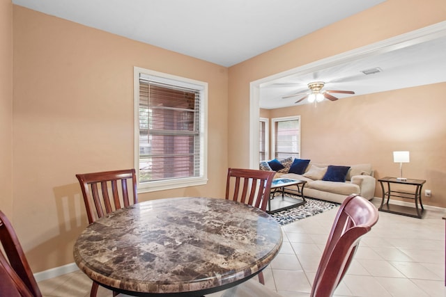 8726 Tilgham St, Houston, TX 77029 - dining space featuring ceiling fan, baseboards, and light tile patterned flooring