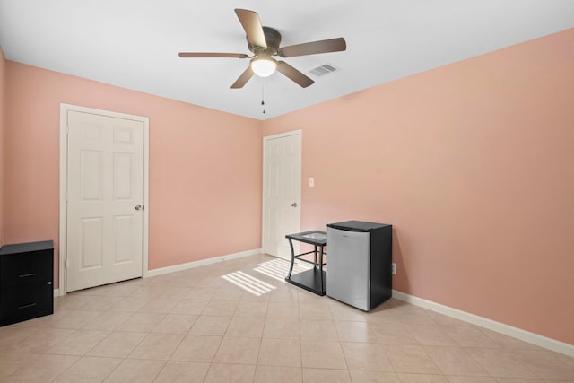 8726 Tilgham St, Houston, TX 77029 - spare room featuring a ceiling fan, baseboards, and light tile patterned floors