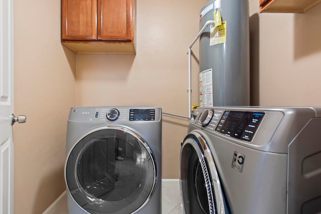 8726 Tilgham St, Houston, TX 77029 - laundry area with washing machine and dryer, water heater, light tile patterned floors, and baseboards