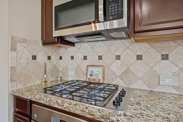 14418 Brushy Arbor Ln, Humble, TX 77396 - kitchen featuring appliances with stainless steel finishes, backsplash, and light stone counters