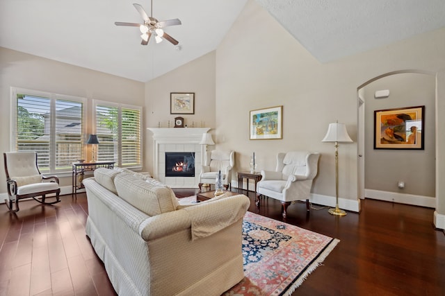 14418 Brushy Arbor Ln, Humble, TX 77396 - living room featuring a ceiling fan, wood finished floors, arched walkways, baseboards, and high vaulted ceiling