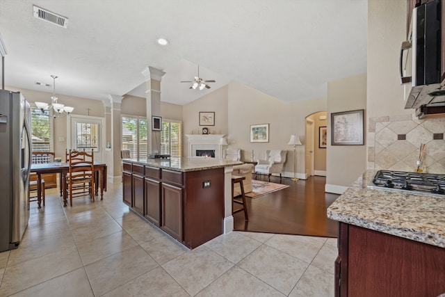 14418 Brushy Arbor Ln, Humble, TX 77396 - kitchen with appliances with stainless steel finishes, plenty of natural light, open floor plan, a ceiling fan, and lofted ceiling