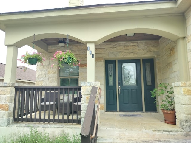 127 Augusta Dr, Woodcreek, TX 78676 - view of exterior entry with stone siding, covered porch, and a ceiling fan