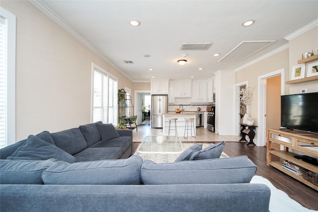 2116 Carter St, Houston, TX 77008 - living room with attic access, light wood-style floors, crown molding, and recessed lighting