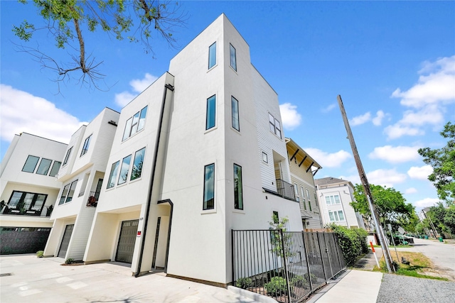 5439 Darling St, Houston, TX 77007 - view of home's exterior featuring a garage, stucco siding, and driveway
