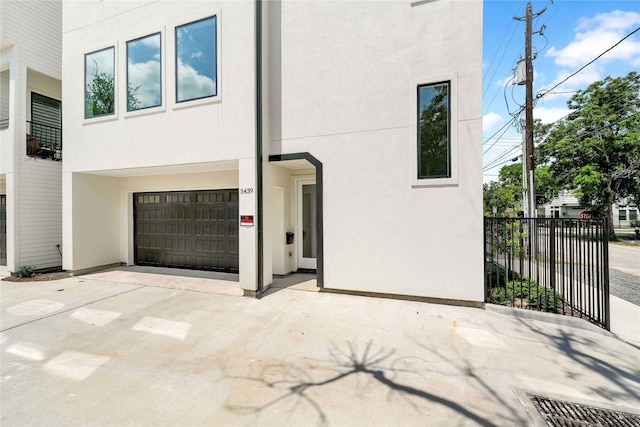 5439 Darling St, Houston, TX 77007 - view of front of home with stucco siding, concrete driveway, and a garage