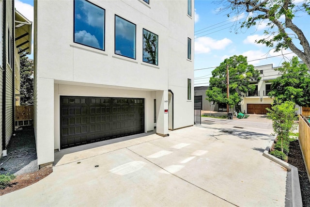 5439 Darling St, Houston, TX 77007 - view of home's exterior with stucco siding, a garage, and concrete driveway