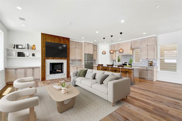 5439 Darling St, Houston, TX 77007 - living area featuring light wood-type flooring, recessed lighting, and a fireplace