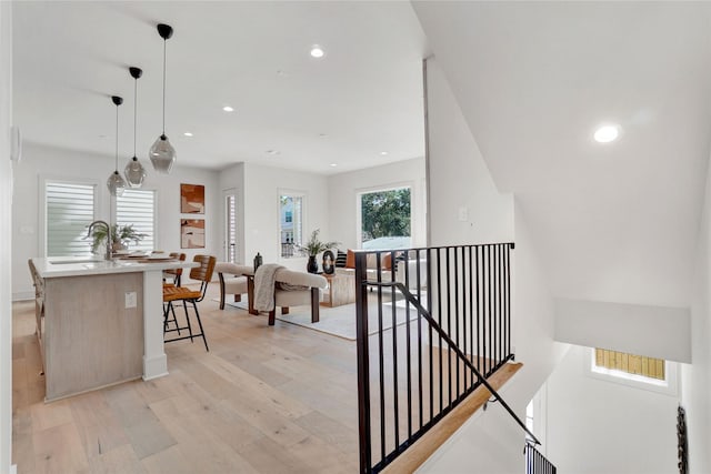 5439 Darling St, Houston, TX 77007 - hall with an upstairs landing, light wood finished floors, recessed lighting, a sink, and baseboards