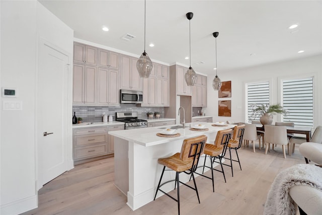 5439 Darling St, Houston, TX 77007 - kitchen featuring appliances with stainless steel finishes, a sink, light wood finished floors, light countertops, and recessed lighting