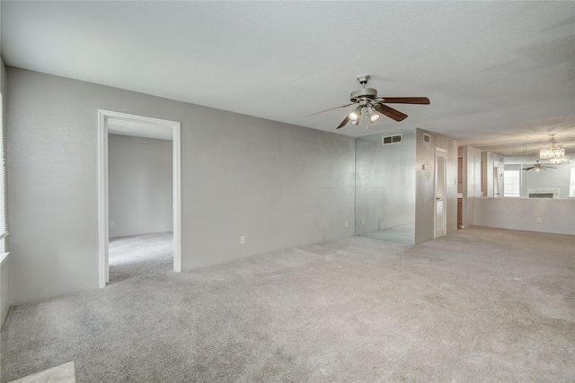 9700 Leawood Blvd Unit 7/16, Houston, TX 77099 - unfurnished living room with ceiling fan, carpet floors, and a chandelier