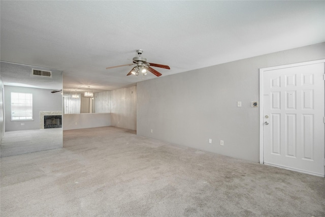 9700 Leawood Blvd Unit 7/16, Houston, TX 77099 - unfurnished living room with carpet flooring, ceiling fan, and a high end fireplace
