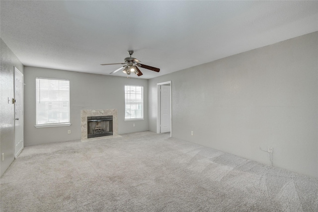 9700 Leawood Blvd Unit 7/16, Houston, TX 77099 - unfurnished living room with carpet flooring, ceiling fan, and a premium fireplace