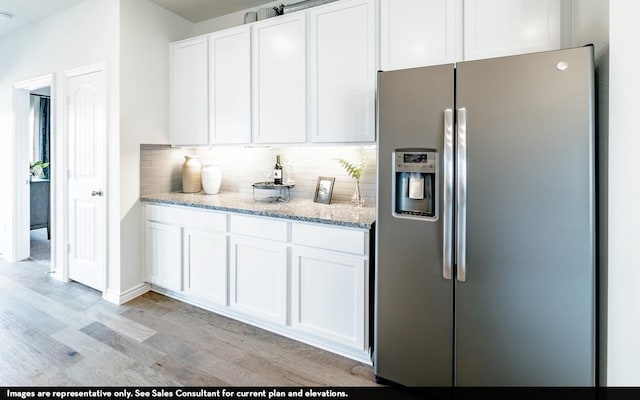 1731 Warm Breeze Dr, Angleton, TX 77515 - kitchen featuring stainless steel fridge, light wood-style flooring, white cabinets, and backsplash