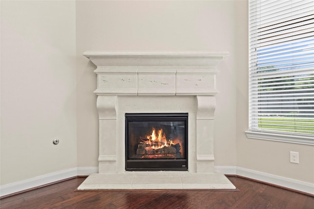 6015 Verde Place Ln, Katy, TX 77493 - detailed view of a fireplace, wood finished floors, and baseboards