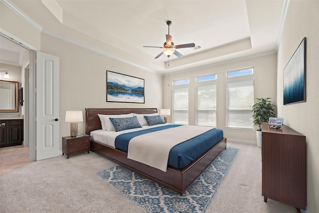 6015 Verde Place Ln, Katy, TX 77493 - bedroom featuring a tray ceiling, ornamental molding, light colored carpet, ceiling fan, and ensuite bath