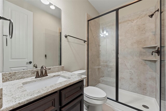 6015 Verde Place Ln, Katy, TX 77493 - full bath featuring toilet, vanity, a stall shower, and a textured wall