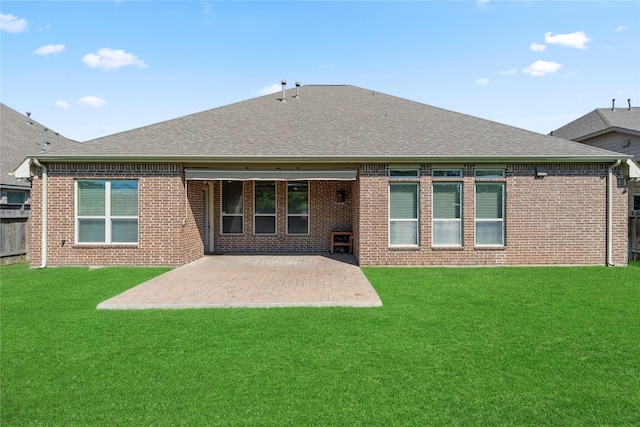 6015 Verde Place Ln, Katy, TX 77493 - back of property featuring roof with shingles, a patio area, brick siding, and a lawn